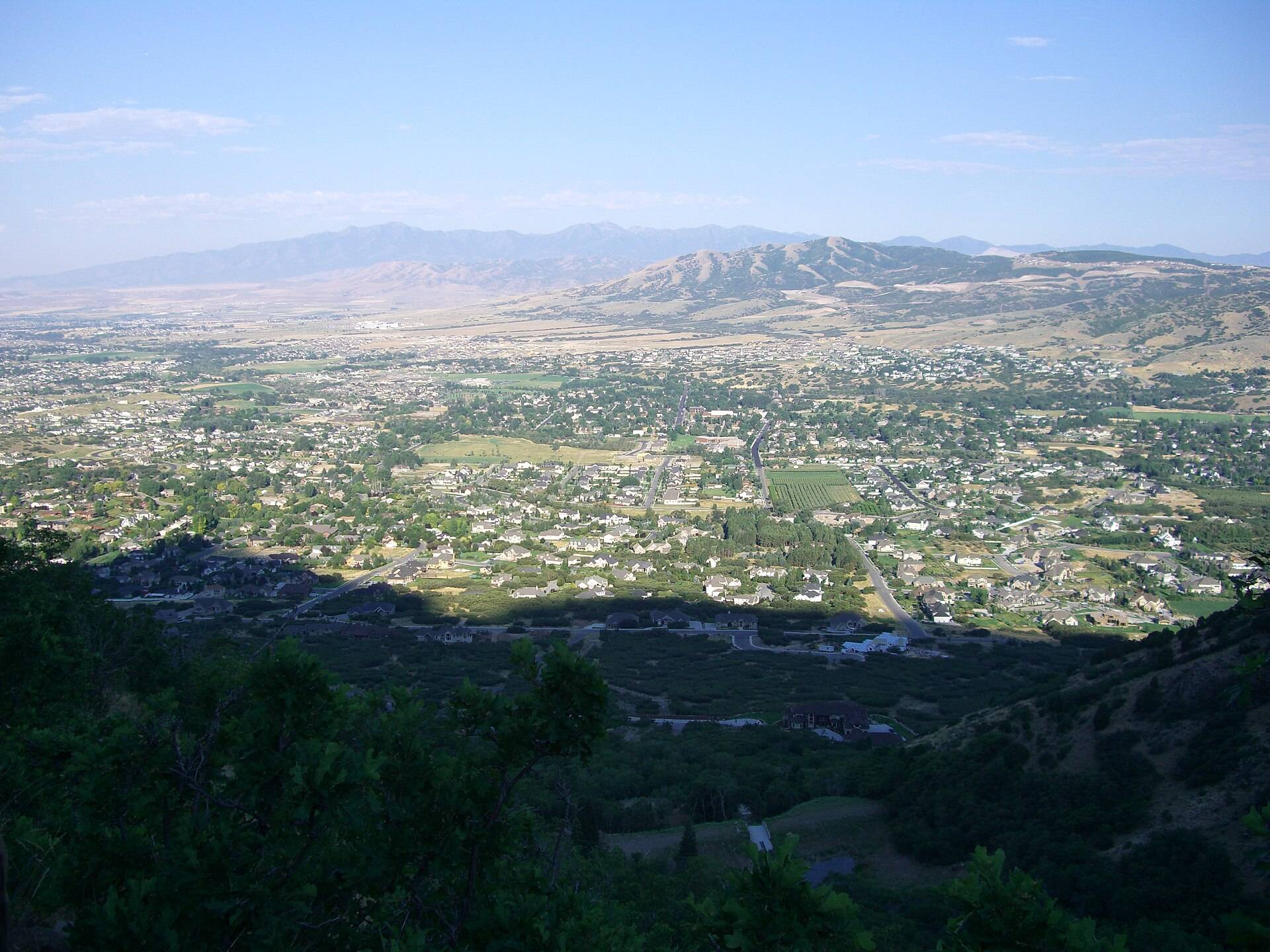 Homes and open fields of Alpine, Utah, seen from the foothills above town, looking west across the valley