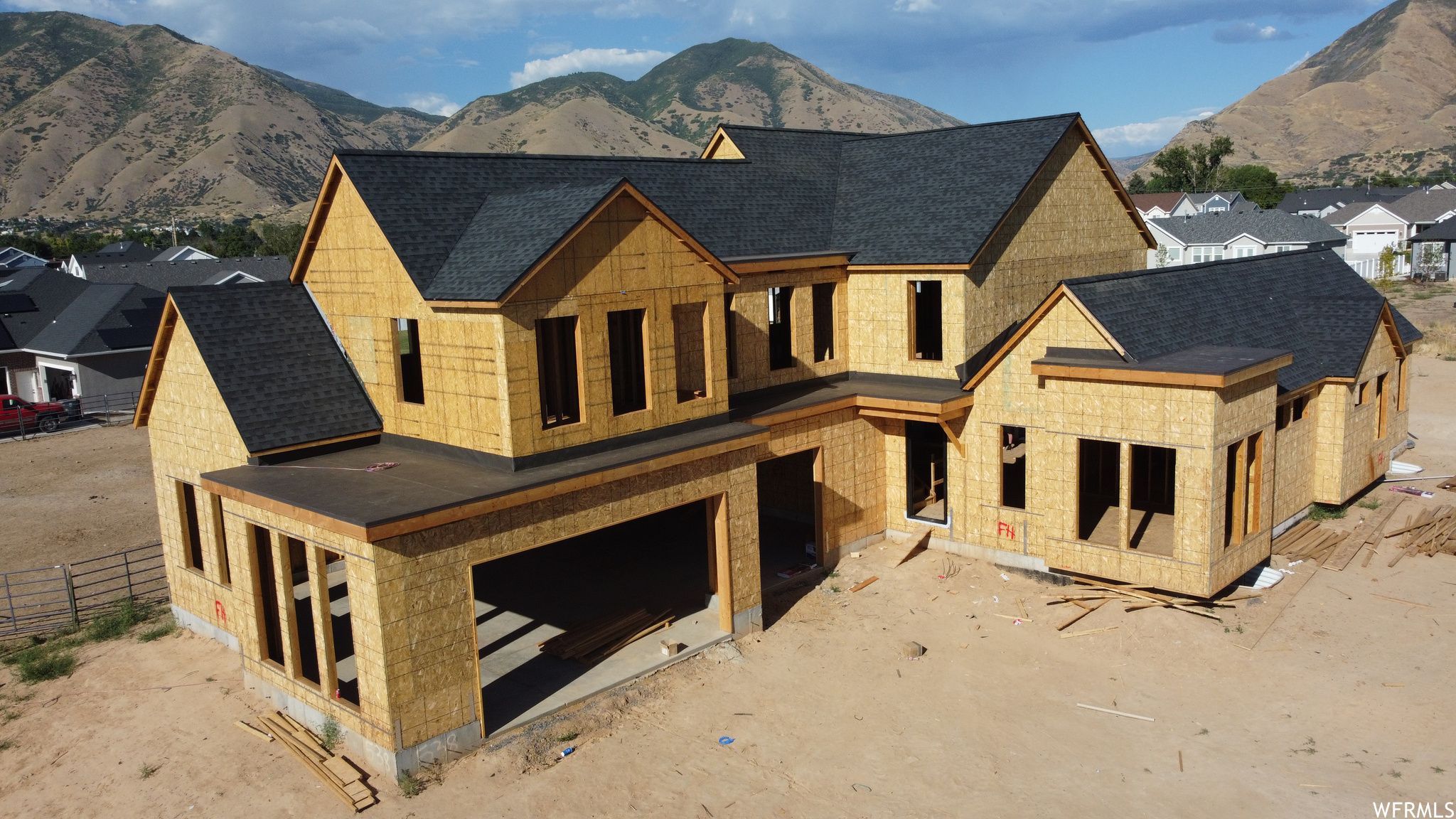 New home in framing below the mountains in Mapleton, Utah