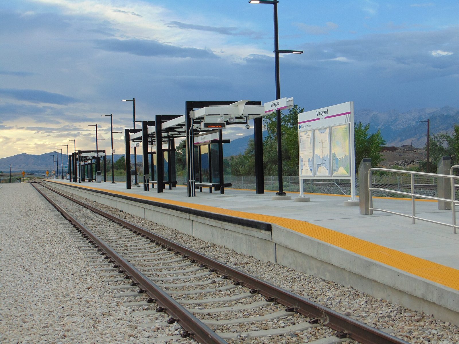 The FrontRunner commuter rail platform at Vineyard station, with mountains in the distance