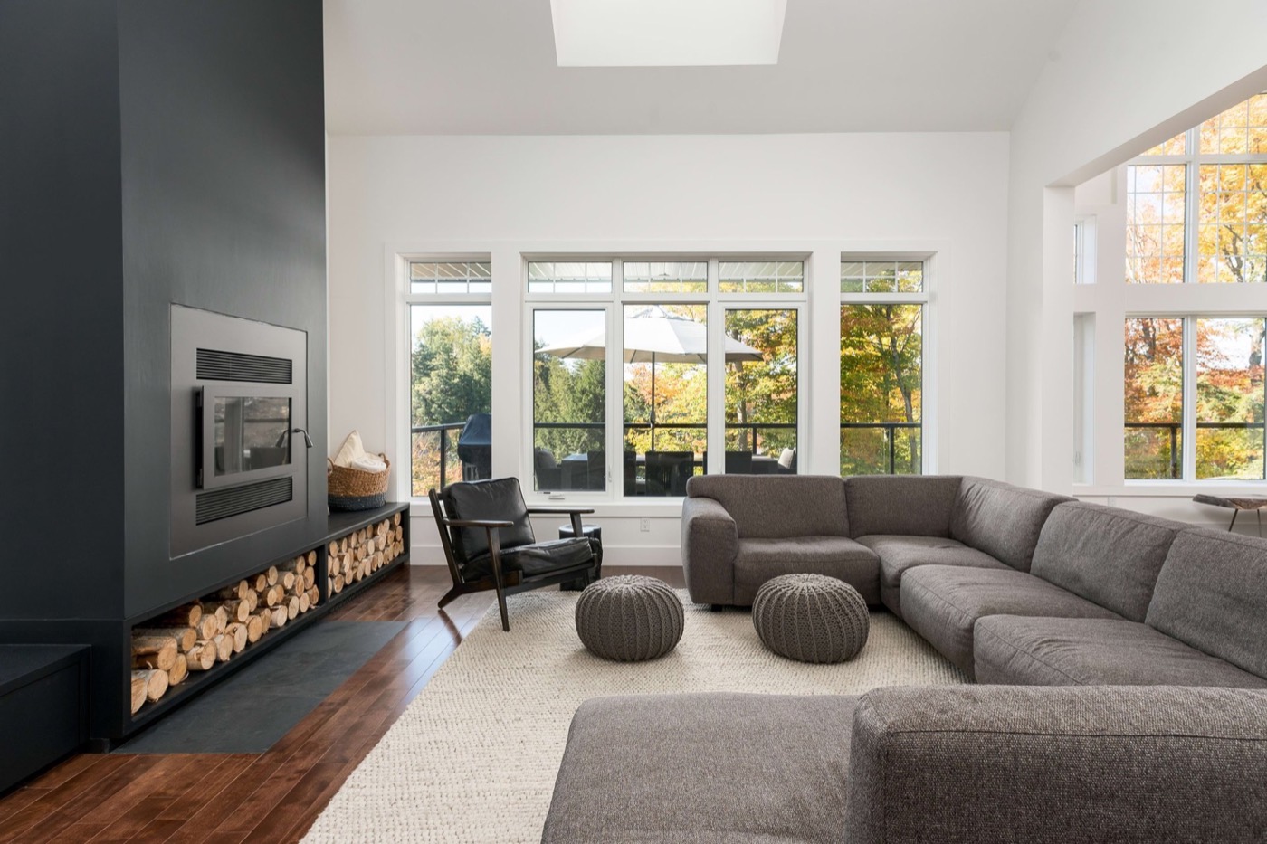 Bright living room with tall windows and a modern fireplace